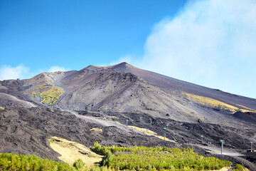 Volcano Etna, Sicily, Italy. Slopes with road and cableway. Crater of Etna. Smoking peak of active volcano Etna.