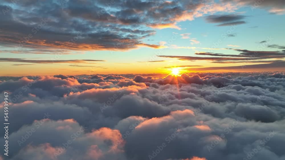 Poster epic sunset over the clouds. warm sun sets over the horizon in clouds. flight in the sky at sunset, 