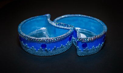 Two purchased blue candlesticks close-up on a black background