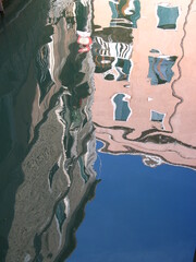 pink reflections in water in Venice, Italian city