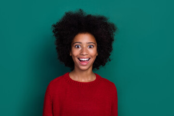 Portrait of astonished cheerful school girl toothy smile unbelievable isolated on green color background