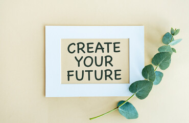 Create Your Future text on white notepad with envelope on yellow background.