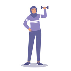 Woman in hijab and sport clother doing sport with dumbbell. Physical activity and sport lifestyle for muslim women.