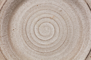 Fototapeta na wymiar Beige ceramic texture of plate with circles.