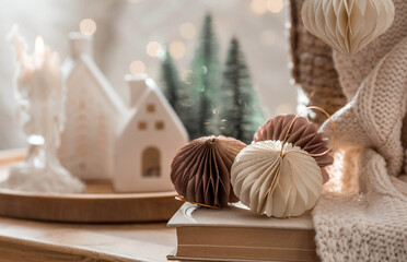 Obraz na płótnie Canvas Stylish paper Christmas tree toys in Scandinavian style. Beige tones. View from above. Banner for design, web pages. The concept of a stylish new year and Christmas 2023.