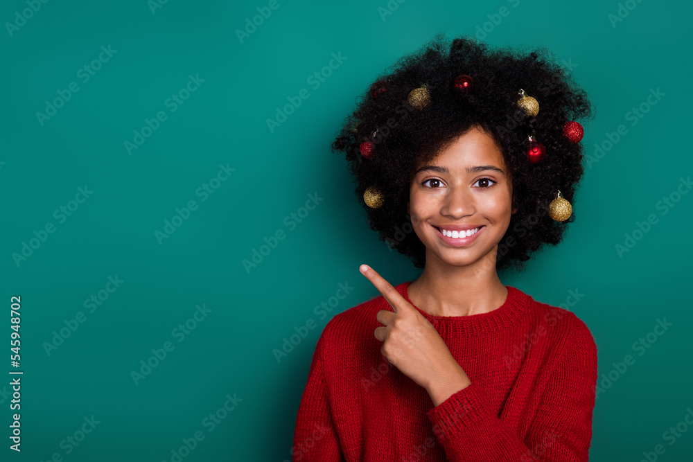 Wall mural Photo portrait of charming small girl point empty space hair decorate card wear trendy red knitted look isolated on green color background