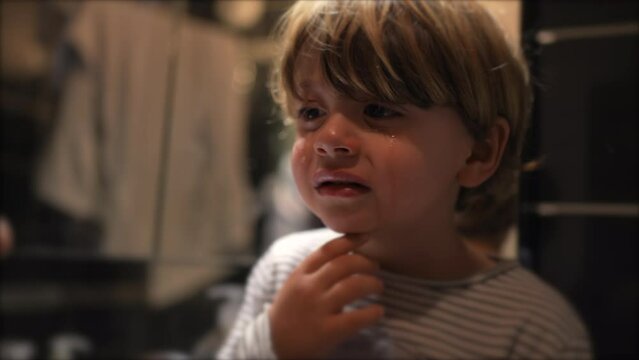 Tearful child crying after getting hurt. One little boy cries. Upset small kid portrait face closeup