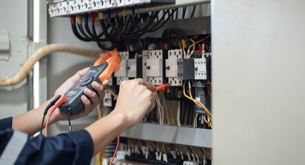 Electrician engineer work tester measuring voltage and current of power electric line in electical...