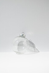 Transparent Christmas bauble decoration on white background. Minimal New Year concept.