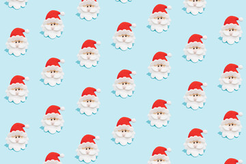 Trendy Christmas Santa Claus pattern on light blue background. Minimal winter holidays concept.