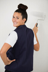 young lad redecorating with a paint roller