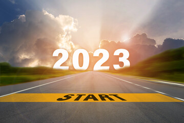 Start to New Year 2023 concept. START word written on highway road in the middle with Number 2023...