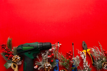 Christmas and new year composition with construction tools, screwdriver and Santa Claus hat on a red background. The concept of building work tools for cards, calendars, covers.