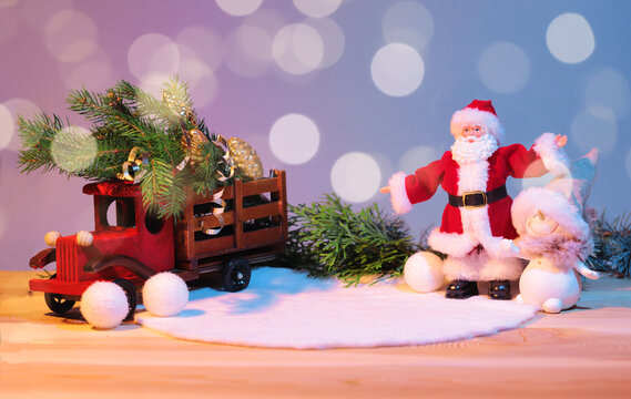 Christmas pedestal for the product, still life composition, with a New Year's car, with a Christmas tree in the back, Santa Claus meets the new year with a snowman, mockup. High quality photo