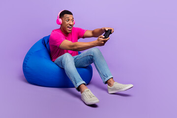 Photo of overjoyed cheerful man trendy outfit sit comfort chair look empty space playstation relax...