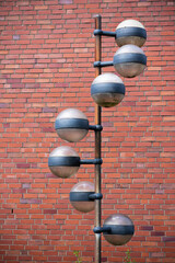 street lamp in front of brick wall in the city
