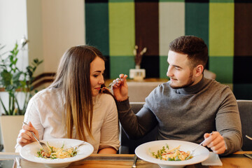 Friends enjoying lunch in the restaurant, eating paste