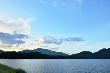 landscape of water reservoir lake with mountain background in sunset