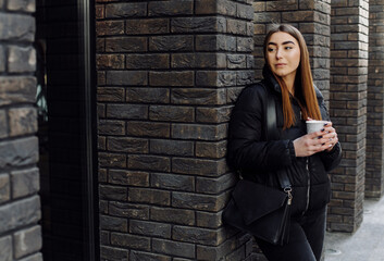 Beautiful girl standing near the wall and pose to camera