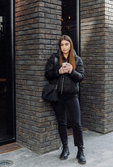 Beautiful girl standing near the wall and pose to camera