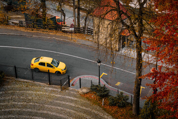 Yellow taxi on autumn street