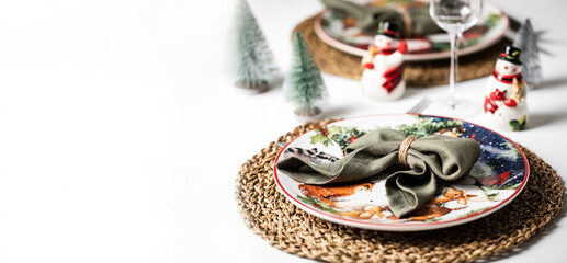 Merry Christmas beautiful table holiday serving with linen towels and kitchen ware decoration with pine trees, wine glass food celebration festive holiday banner copy space