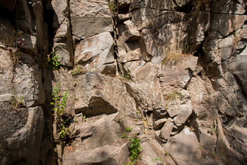 Picturesque textured high cliffs from large stones as a background for your design or illustrations.