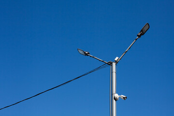 A modern street LED lighting pole for sity with blue sky. Urban electro-energy technologies....
