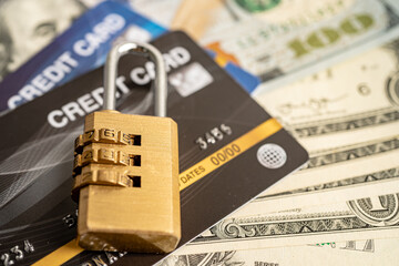 Credit card with password key lock security on US dollar background.