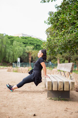 Fototapeta premium Pretty fat woman doing outdoor exercises