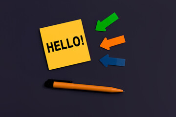 Hello salutation or greeting word to welcome someone or initiate a conversation. Communication concept, introduction. Yellow square sticky note, pen and arrows of paper on dark color background