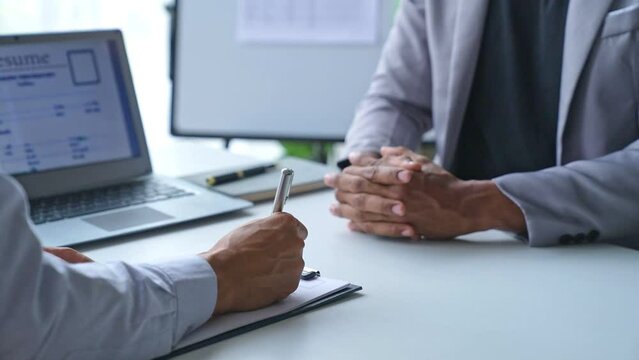 Businessman having an interview for a job, Company hr reading candidate's CV, and interviewing