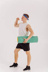 Athletic young man doing workouts at home, man doing training, warm up before weight exercise.