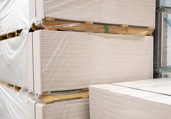 Chipboard in the package is stacked in bundles on top of each other. Construction and structural materials. Floor covering