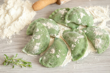 Green dumplings with spinach. The dumplings are just molded, but not yet ready to eat. They need to...