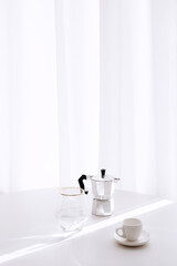 Fototapeta na wymiar copy space white room with coffee cup glass of water on white table