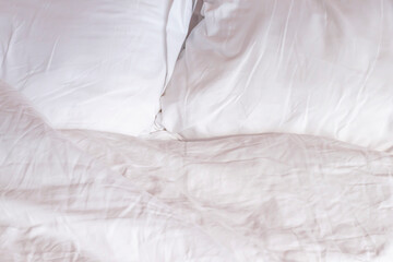 White pillow and bedding background in bedroom with copy space.