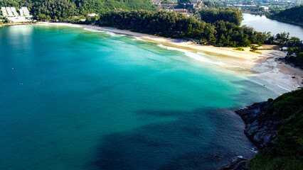 Aerial view of beautiful tropical beach of Nai Harn on Phuket island, Thailand. Sunny morning light.