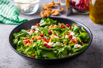 Arugula salad with cheese served with walnuts and pomegranate. Turkish name; Roka salatasi