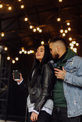 Outdoor happy couple in love posing near cafe