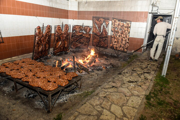 Gaucho roast barbecue, sausage and cow ribs, traditional argentine cuisine, Patagonia, Argentina.