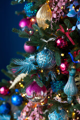 Close up of balls on Christmas tree. Bokeh garlands in the background. New Year and Christmas concept.