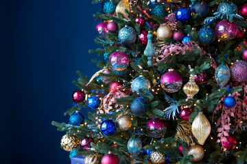 Close up of balls on Christmas tree. Bokeh garlands in the background. New Year and Christmas concept.