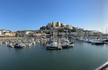 Fototapeta na wymiar Panoramic shot with boats in a harbour on a sunny day. Torquay, Devon, England