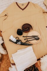 Vertical shot of a traditional robe and hunting weapons and equipment at a tent accommodation