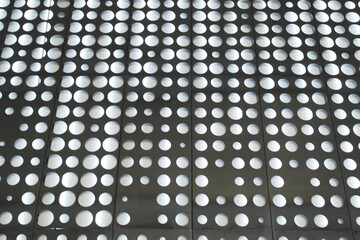 Background with dark perforated metal sheet