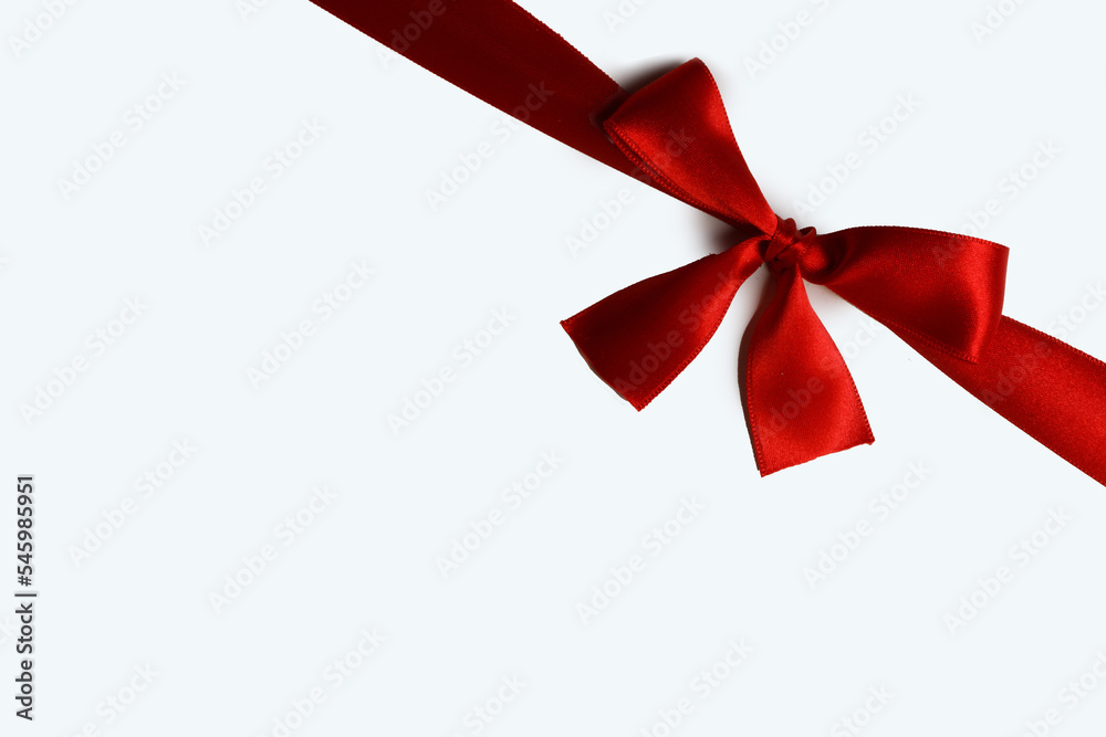 Wall mural Red ribbon bow isolated on white