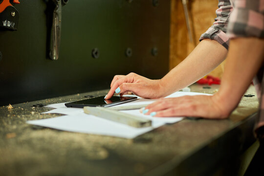 Female business owner using digital tablet in workshop