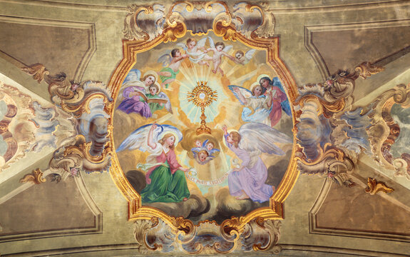 VARALLO, ITALY - JULY 17, 2022: The baroque ceiling fresco of Eucharistic adoration of angels in the church Collegiata di San Gaudenzio by Carlo Bartolomeo Borsetti (1702).