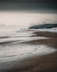 Vertical shot of the sandy beach of the Baltic Sea in Latvia on a winter day